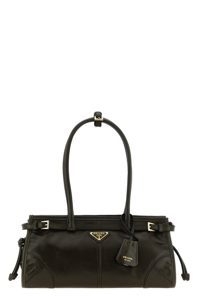 the prada bonnie midi handbag stands out for its elongated rectangular silhoue