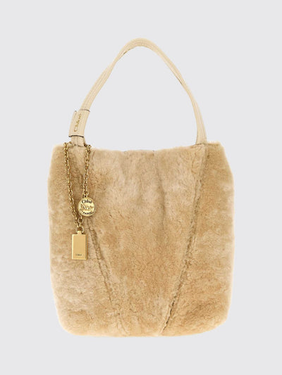 chloé spin shearling shoulder bag with double handle and decorative charm