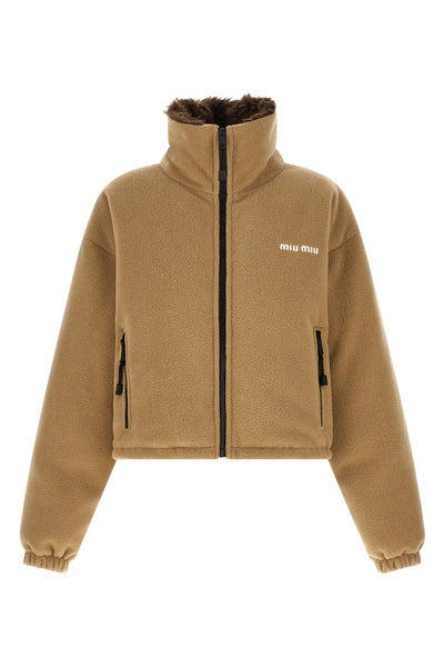 miu miu short down jacket redefines volumes through a compact and structured sil