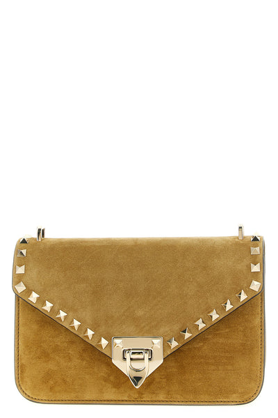 the valentino garavani rockstud small shoulder bag in beige suede stands out f