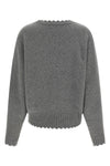 the nude v-neck sweater redefines knitwear codes through a deconstructed aesthet
