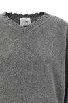 the nude v-neck sweater redefines knitwear codes through a deconstructed aesthet