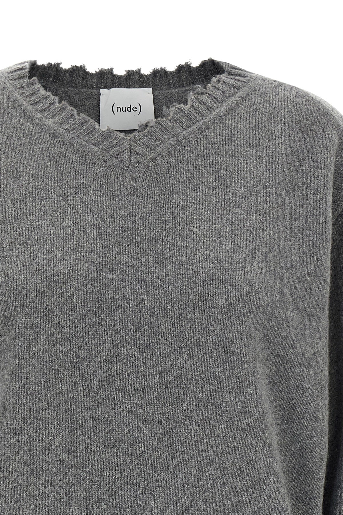 the nude v-neck sweater redefines knitwear codes through a deconstructed aesthet