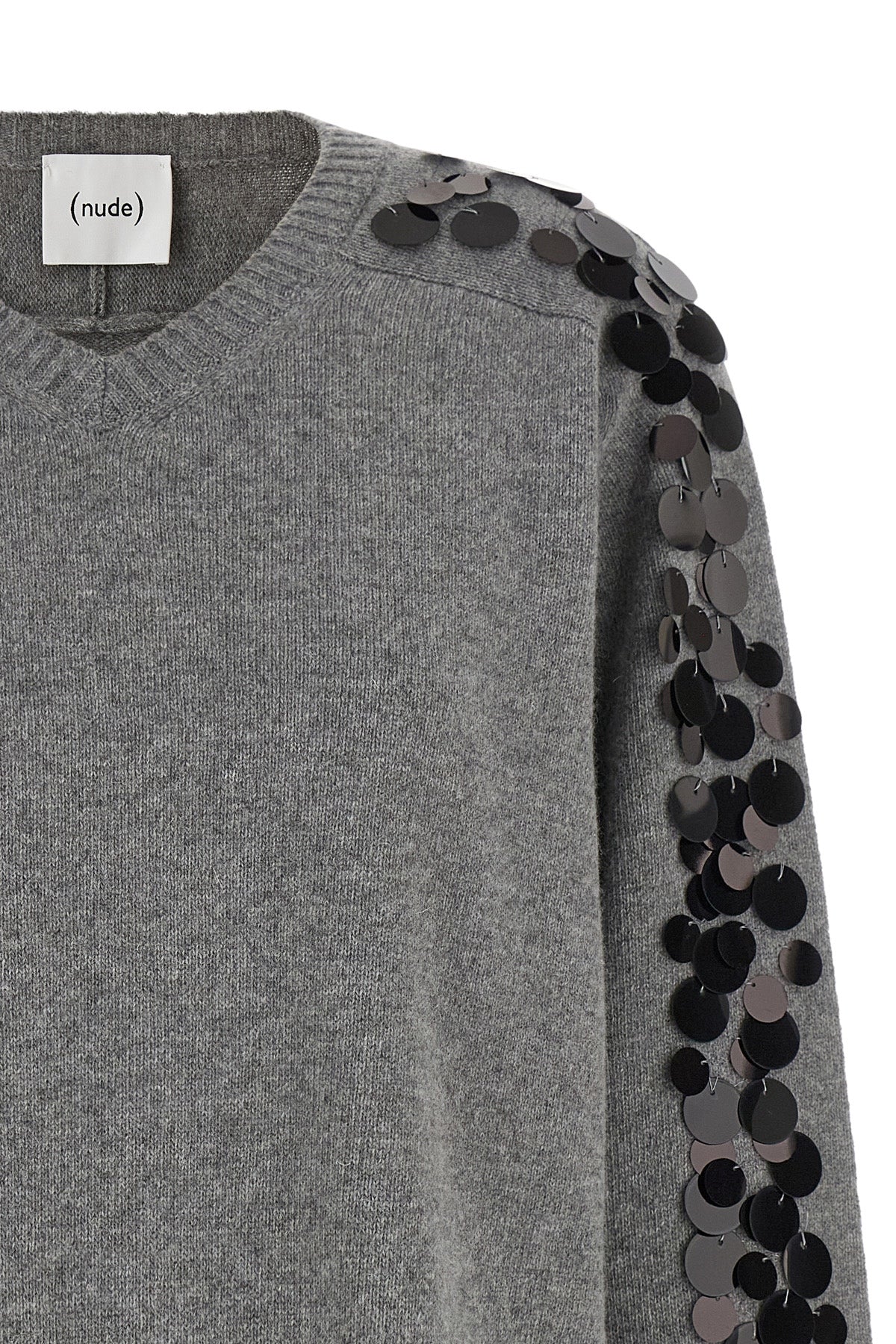 the nude knit redefines the elegance of knitwear through a bold material contras