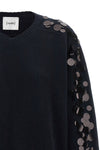 the nude knit redefines contemporary knitwear through a bold material contrast