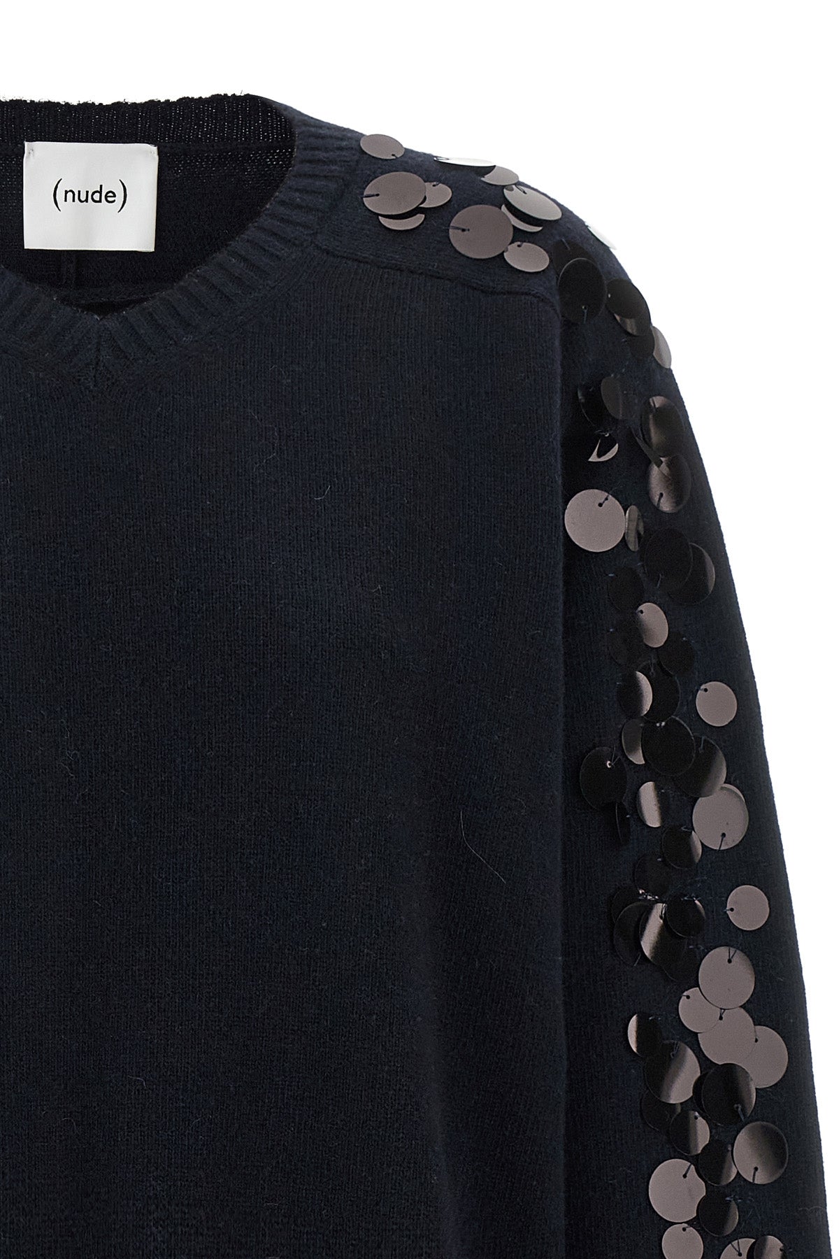 the nude knit redefines contemporary knitwear through a bold material contrast