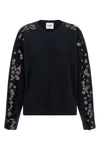 the nude knit redefines contemporary knitwear through a bold material contrast