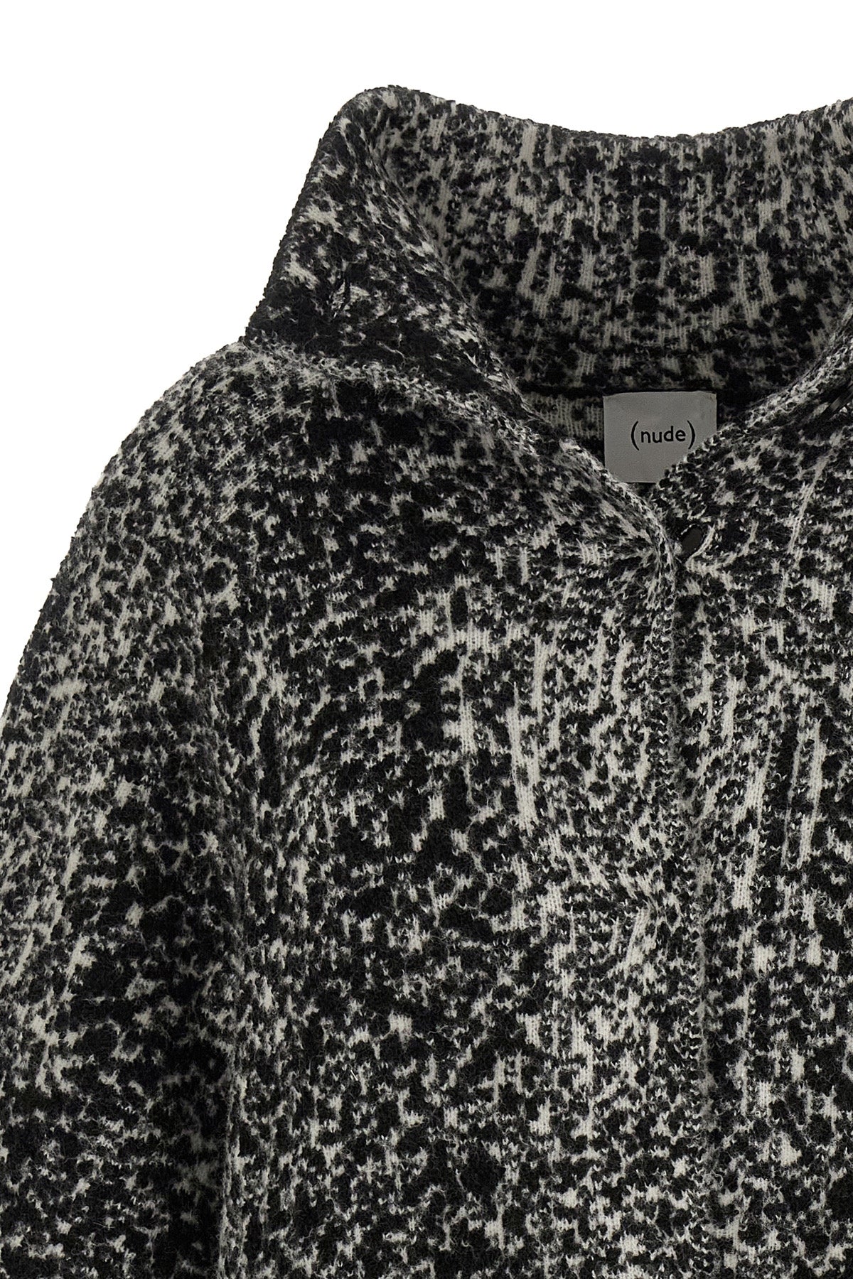 the nude knit coat redefines the volumes of contemporary outerwear through a cap
