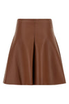 the nude mini skirt defines a flared silhouette