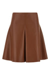 the nude mini skirt defines a flared silhouette