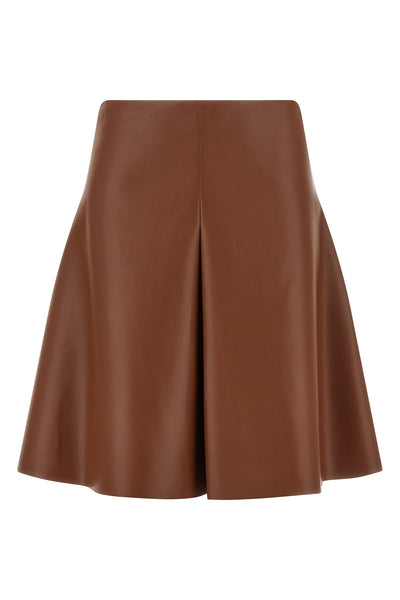the nude mini skirt defines a flared silhouette