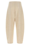 nude trousers redefine sartorial volumes through a distinctive balloon silhouett