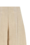 nude trousers redefine sartorial volumes through a distinctive balloon silhouett