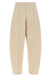nude trousers redefine sartorial volumes through a distinctive balloon silhouett