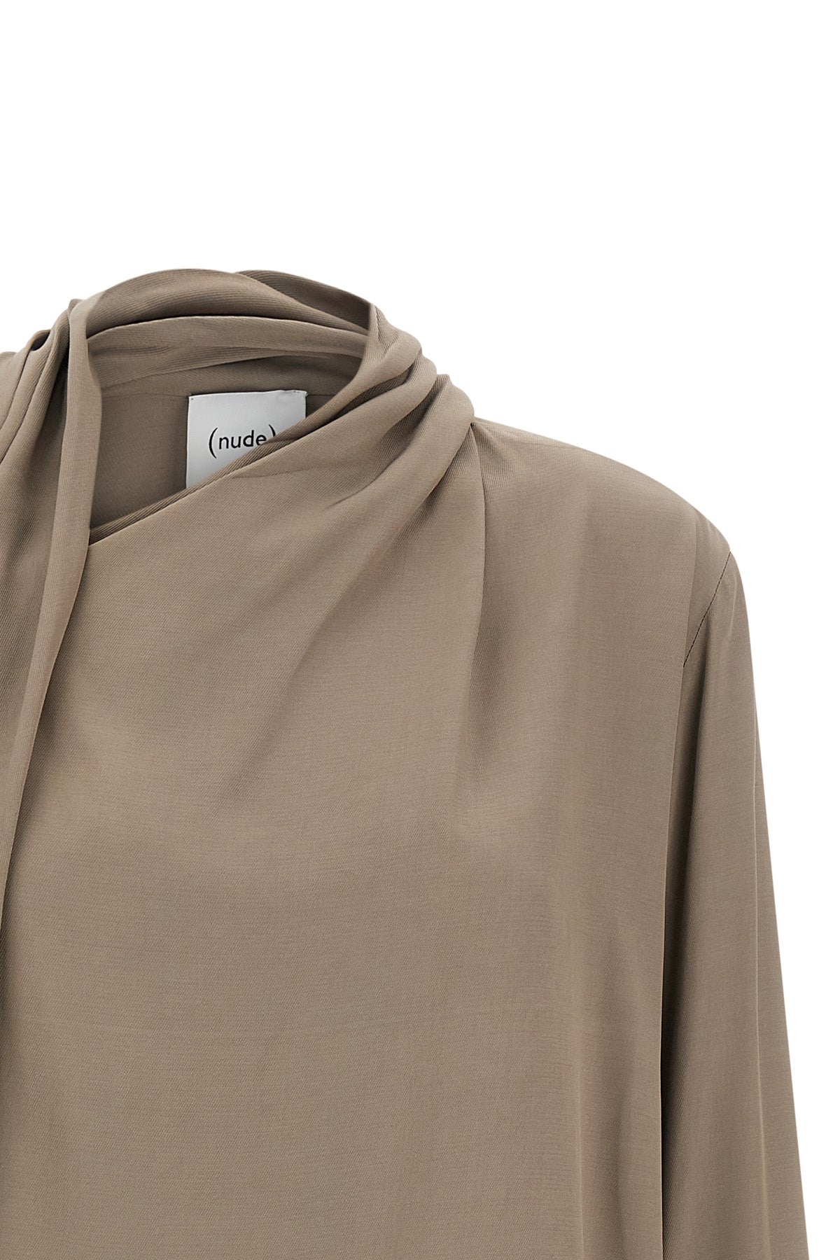 the nude blouse is distinguished by a fluid silhouette and an asymmetrical desig