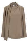 the nude blouse is distinguished by a fluid silhouette and an asymmetrical desig