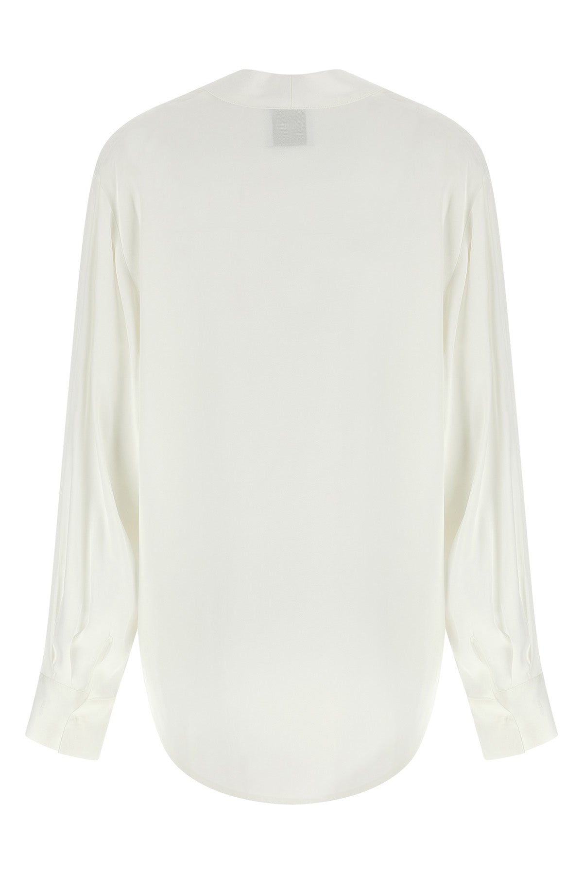 the nude blouse is distinguished by a fluid and deconstructed silhouette