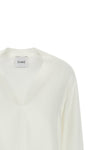 the nude blouse is distinguished by a fluid and deconstructed silhouette