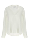 the nude blouse is distinguished by a fluid and deconstructed silhouette