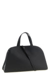 the romy tory burch trunk bag stands out for its structured and rounded silhouet