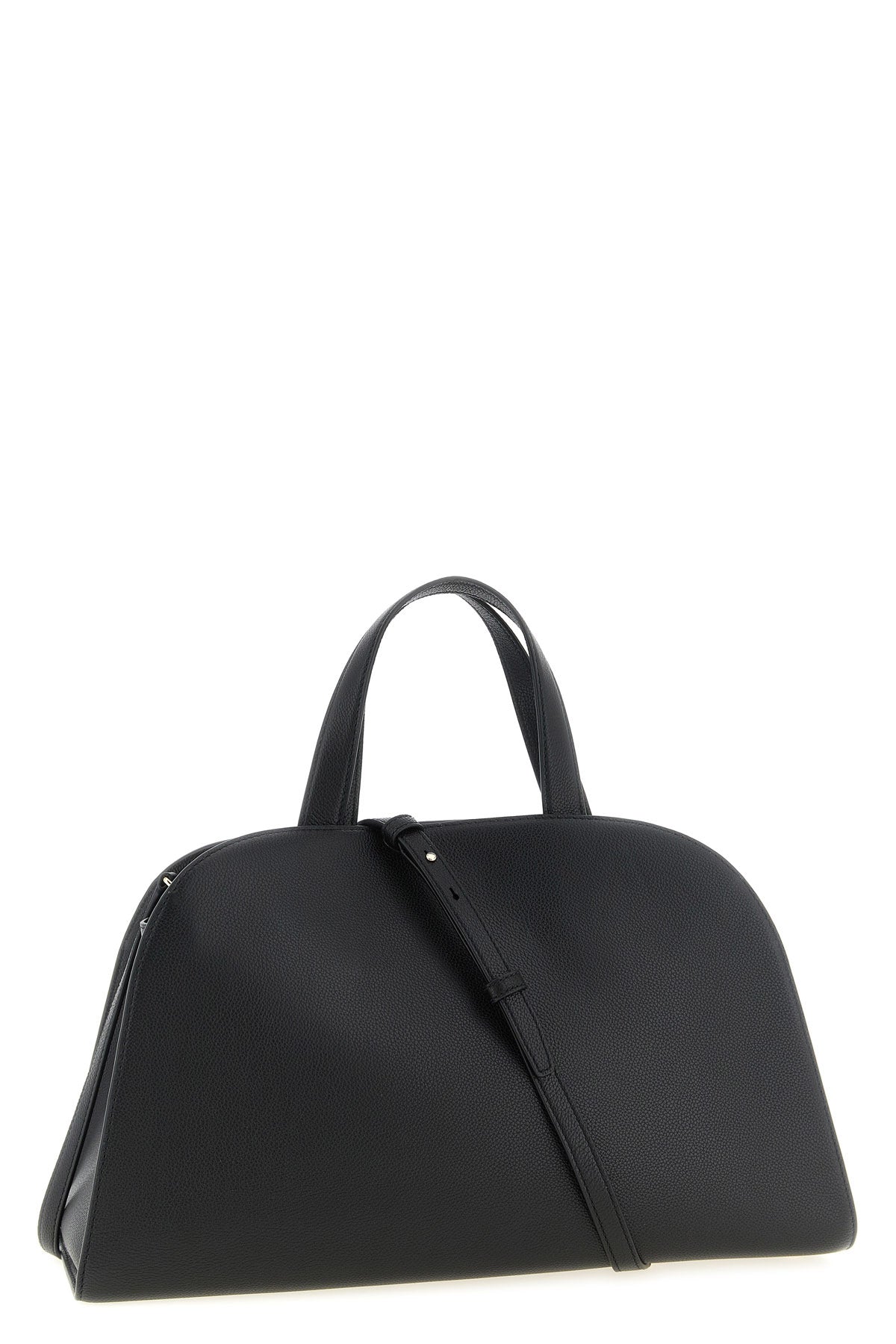 the romy tory burch trunk bag stands out for its structured and rounded silhouet