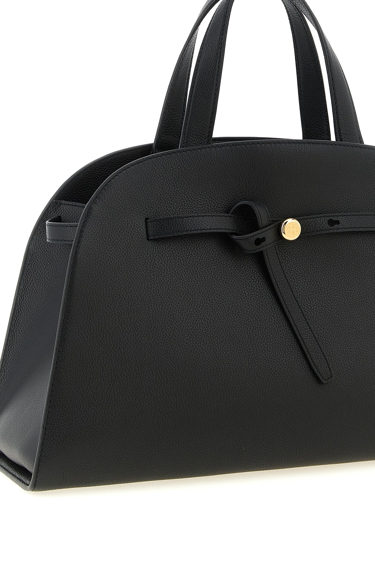the romy tory burch trunk bag stands out for its structured and rounded silhouet