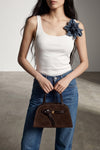 the tory burch romy small bauletto bag redefines everyday elegance through a sop