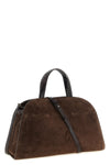the tory burch romy trunk bag embodies a material elegance through the contrast