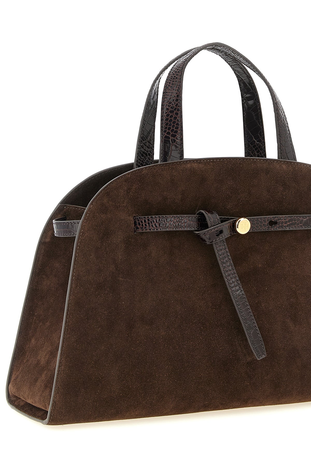 the tory burch romy trunk bag embodies a material elegance through the contrast