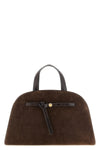 the tory burch romy trunk bag embodies a material elegance through the contrast