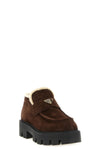 prada loafers redefine the classic silhouette through contemporary volumes and c
