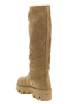 prada high boots redefine winter proportions through a structured silhouette