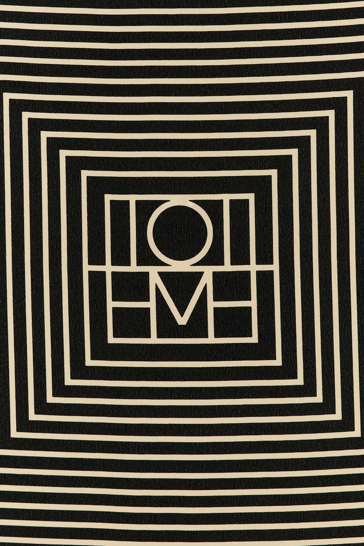 the toteme centered monogram scarf redefines everyday elegance through versati