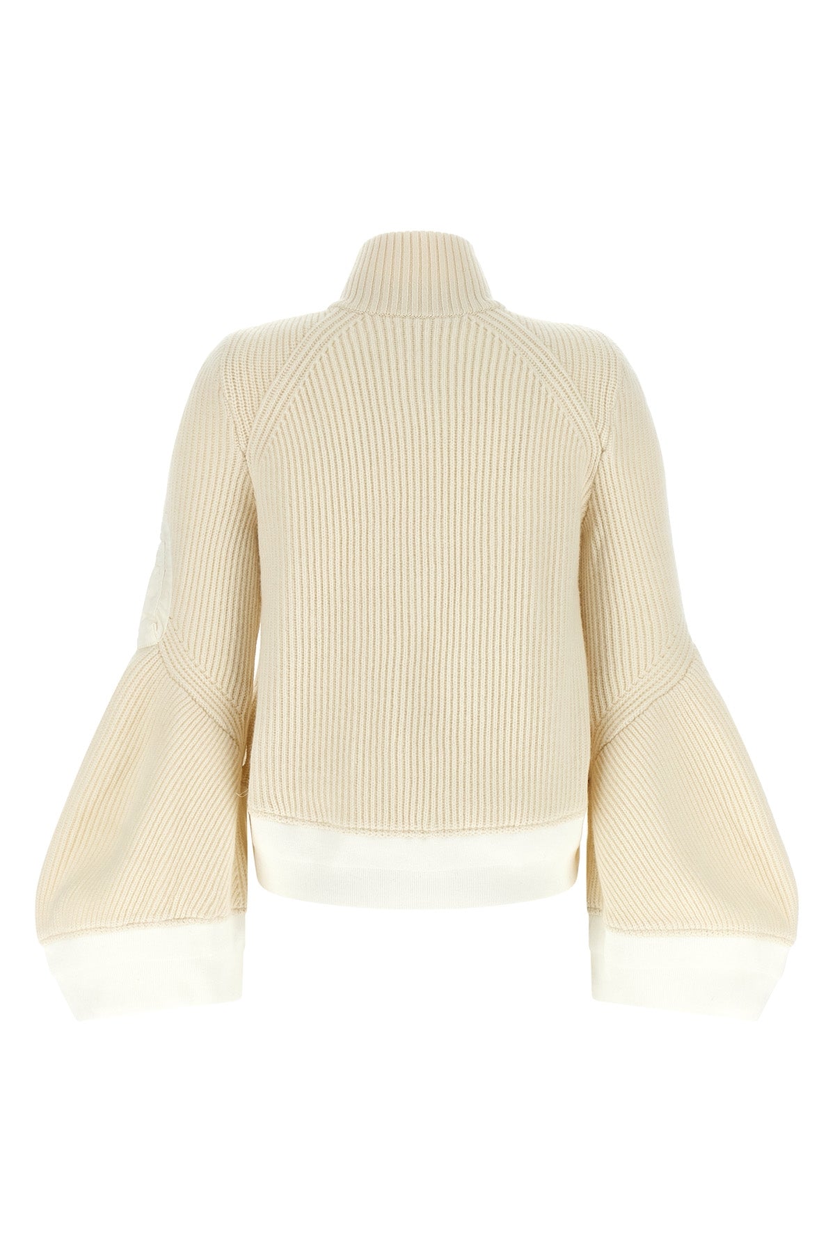 the sacai wool knit blouson exemplifies the brands distinctive hybrid construct