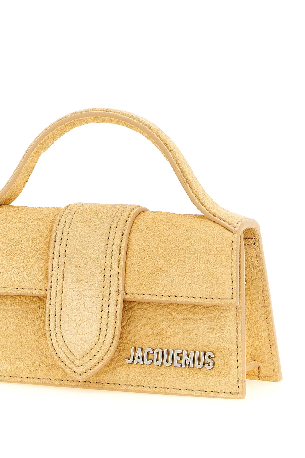 the jacquemus le bambino handbag defines a structured trapezoidal silhouette