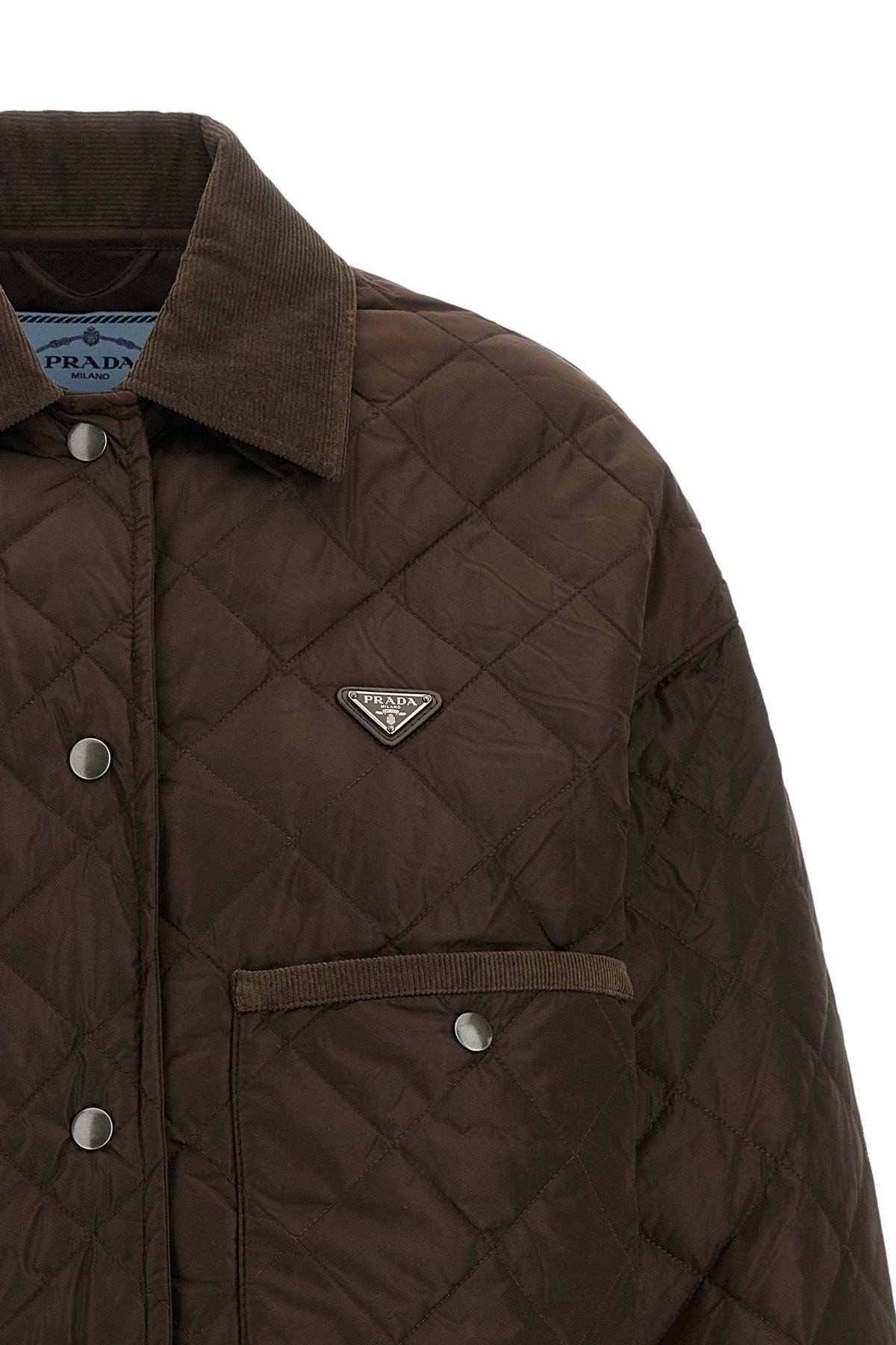 prada cropped blouson defines a new functional aesthetic through compact volumes