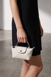 the longchamp xs le pliage xtra clutch redefines the codes of everyday eleganc