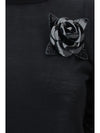 high-neck sweater with flower brooch