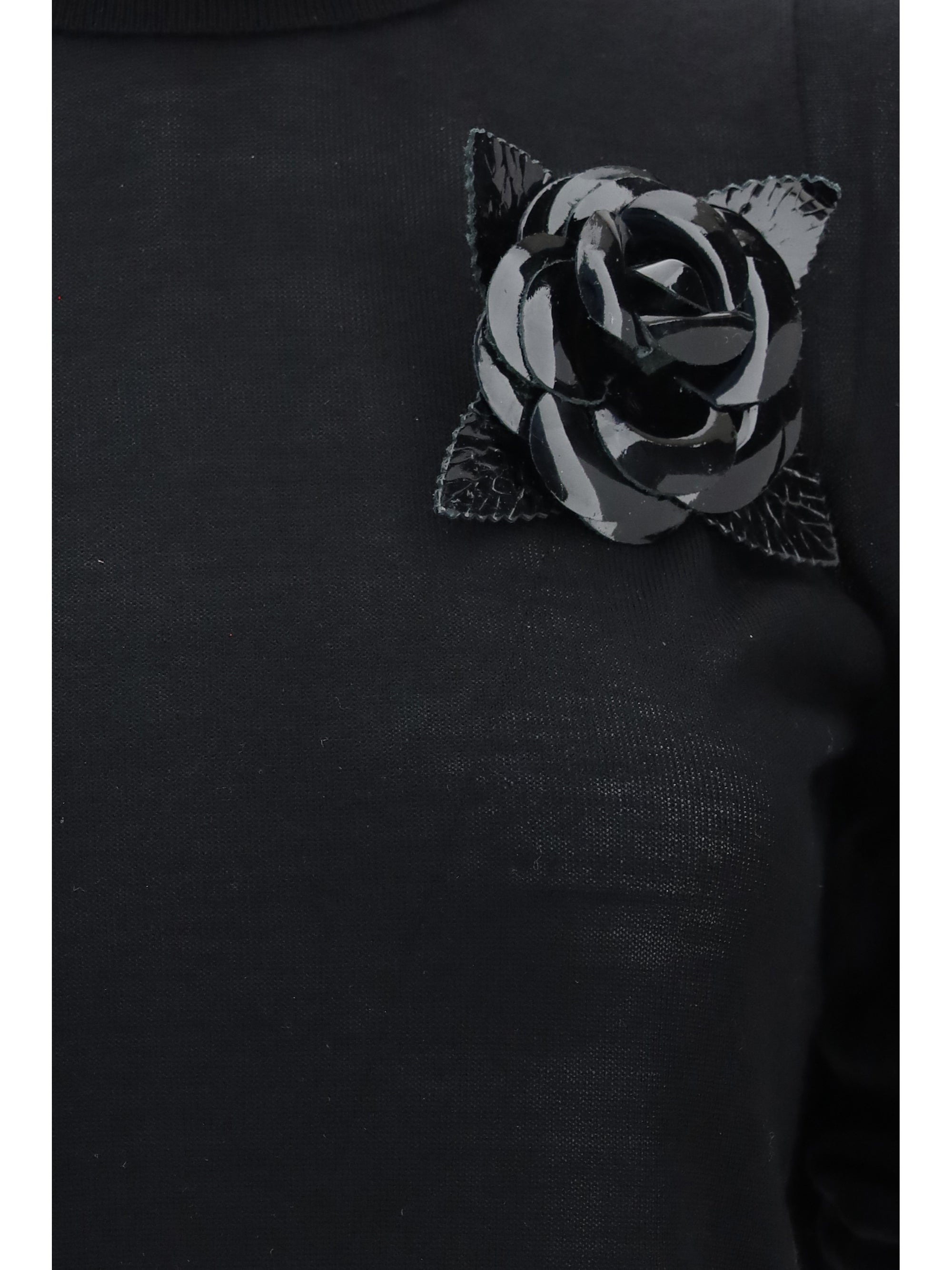 high-neck sweater with flower brooch
