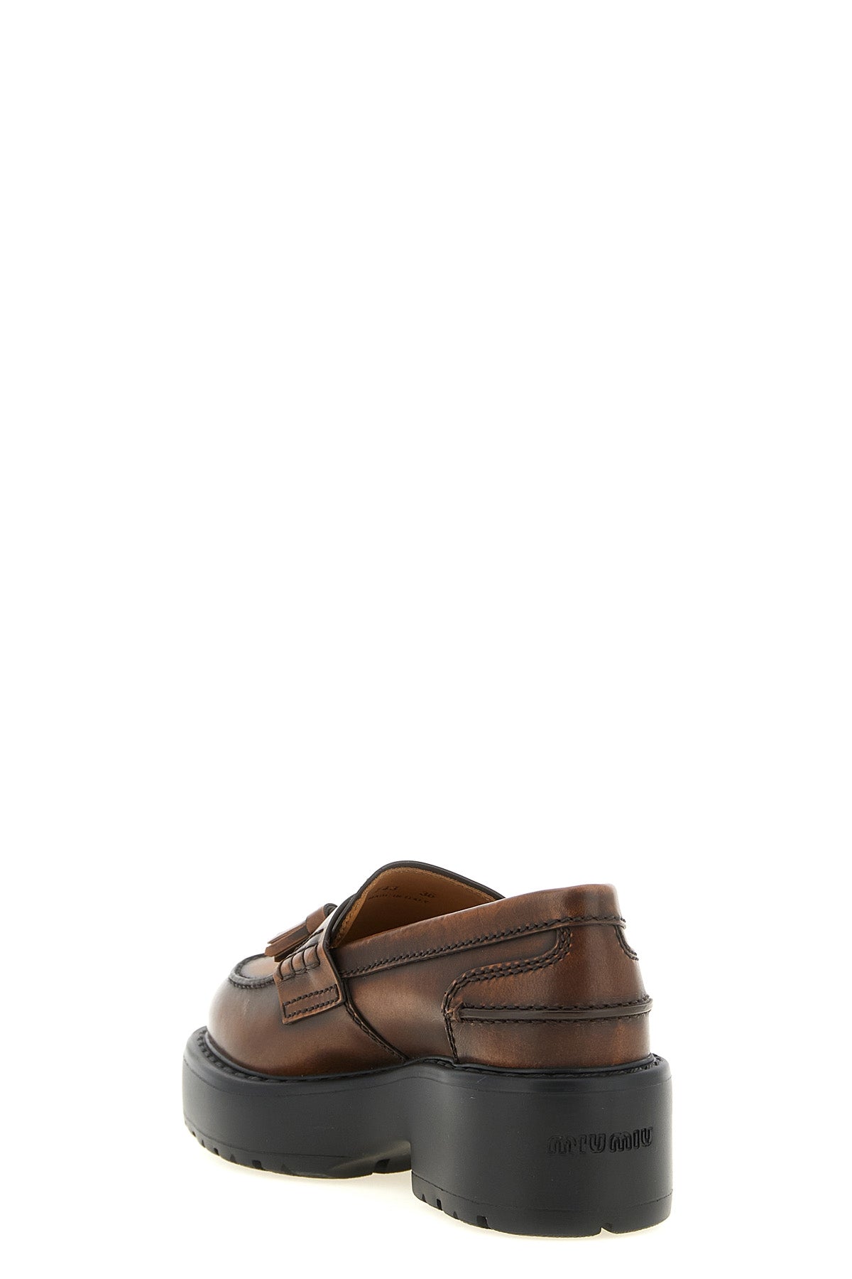 miu miu loafers redefine classic footwear through a structural and bold lens