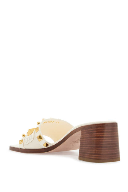 ivory leather slippers with golden studs and low heel