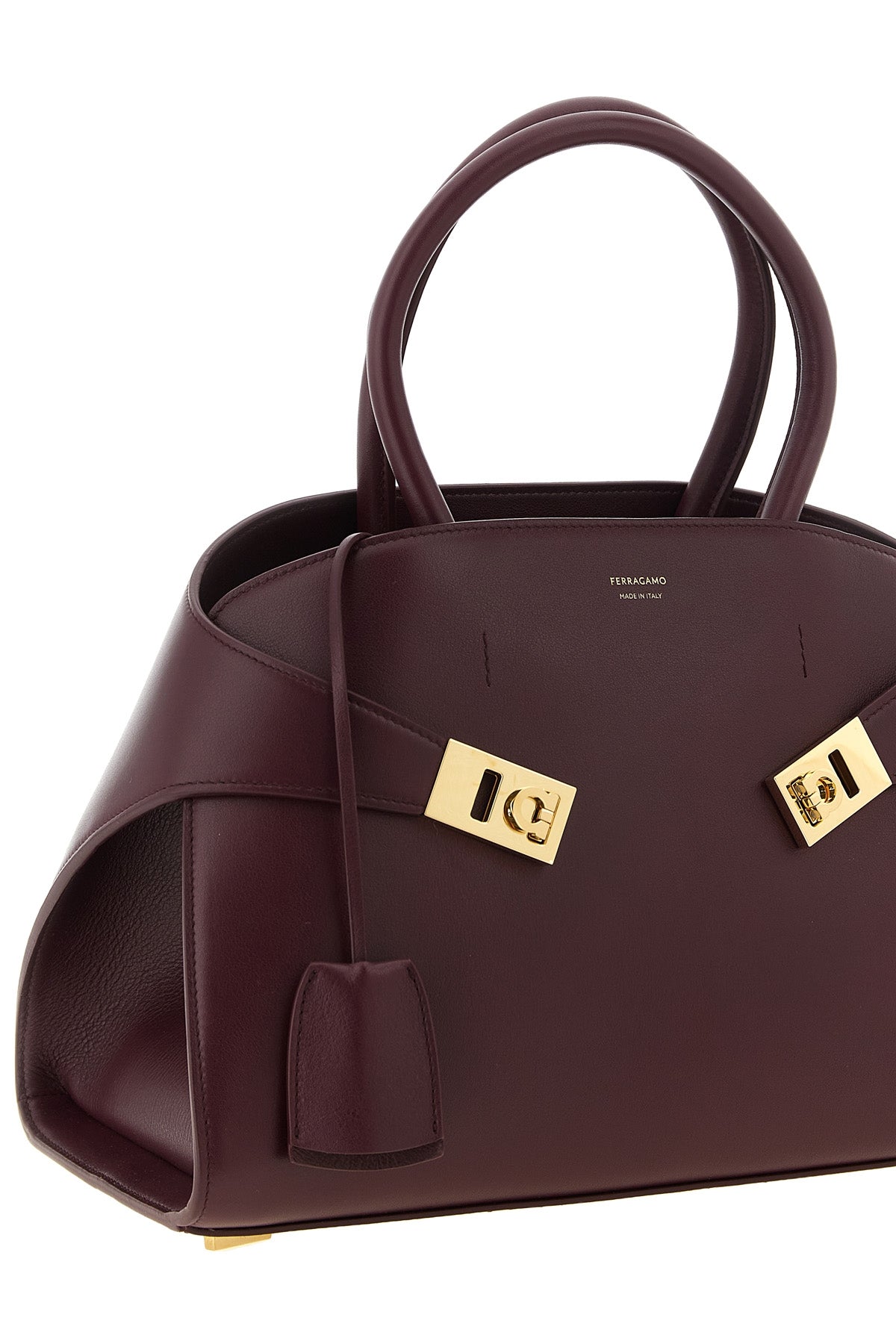 ferragamos hug (m) handbag in fine burgundy hammered calf leather stands out