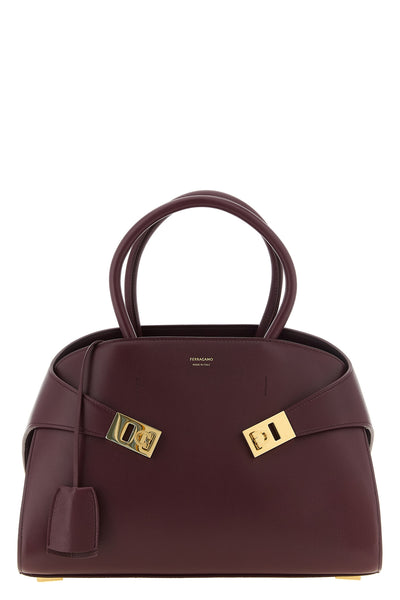 ferragamos hug (m) handbag in fine burgundy hammered calf leather stands out