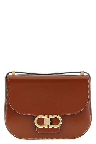 the ferragamo double gancini crossbody bag is made of pure smooth and shiny calf