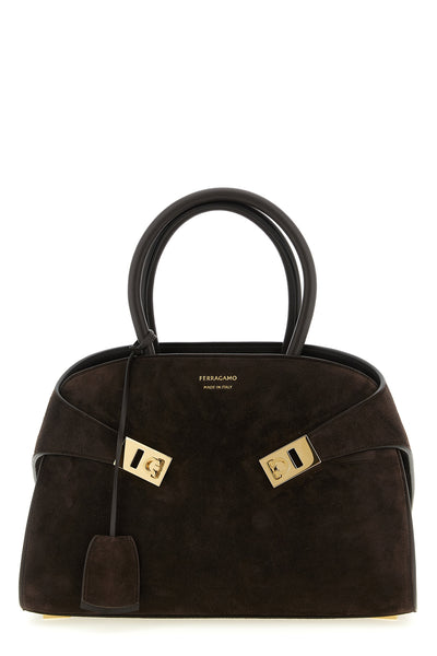 the ferragamo hug th (s) handbag sets new standards in sartorial architecture
