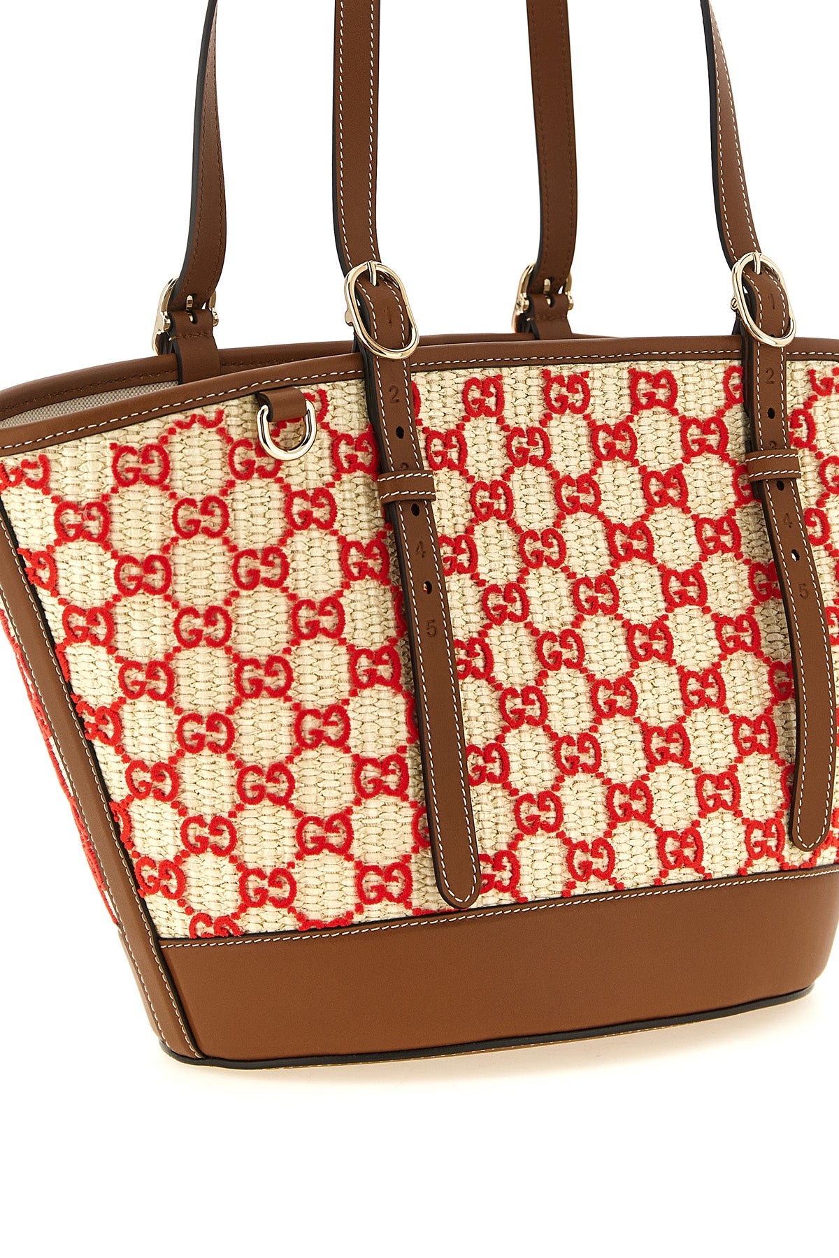 the small gucci woven fabric shopping bag has a flared shape defined by a contra