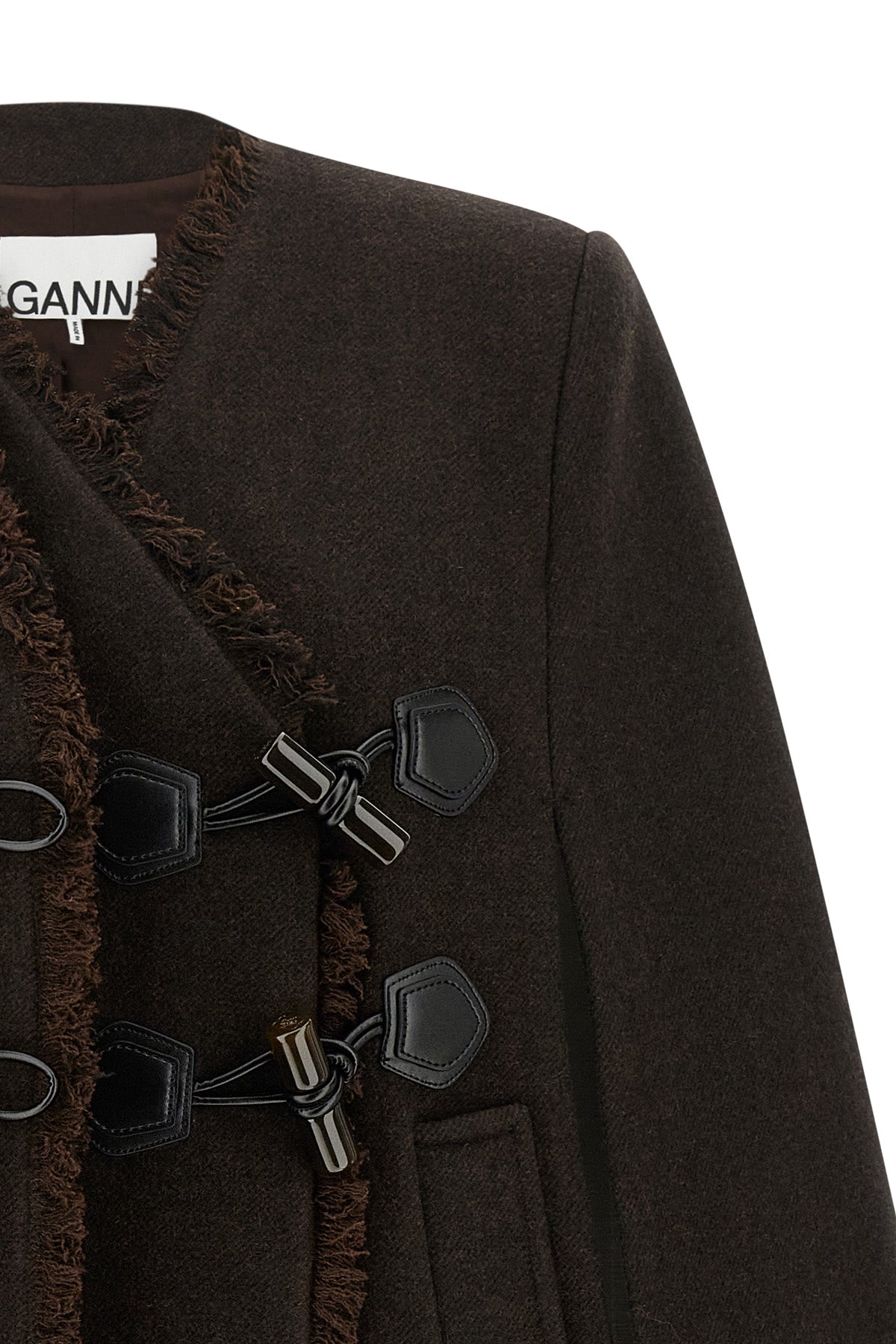 the ganni cape redefines the volumes of the outerwear through a flared and envel