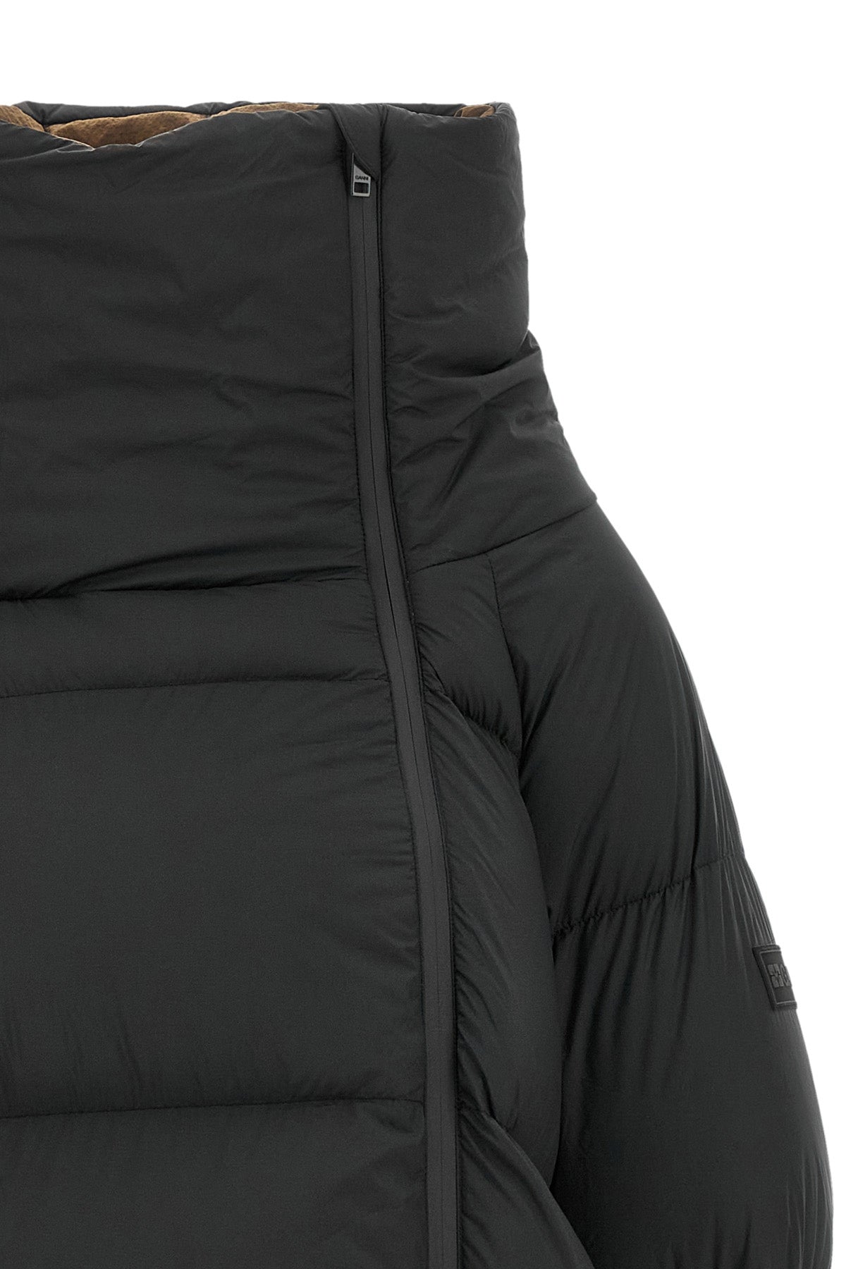 the black ganni down jacket is distinguished by a voluminous silhouette and asym