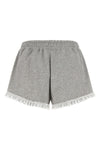 the ganni isoli shorts redefine casual style through a precise balance of text