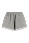 the ganni isoli shorts redefine casual style through a precise balance of text